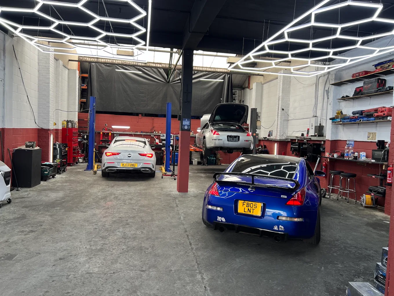 Our workshop in Luton, with cars in the service bays